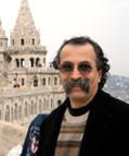 Rich Falco outdoors beside a historic stone building